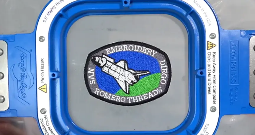 tack-down stitch that holds the badge